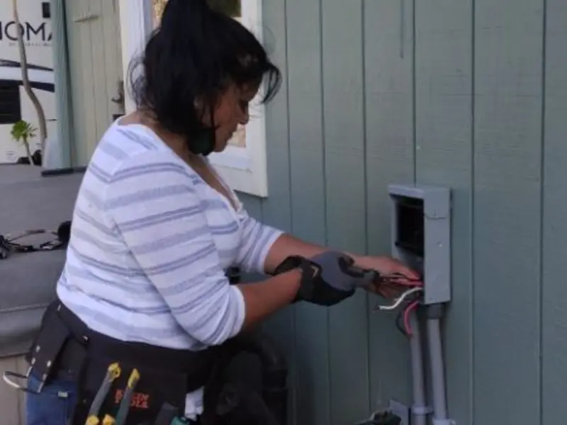 Licensed electrician wiring an exterior subpanel in Chickasha