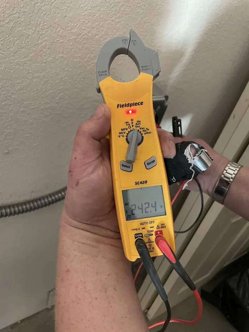Voltage testing with clamp meter during Recessed Lighting Installation in Chickasha